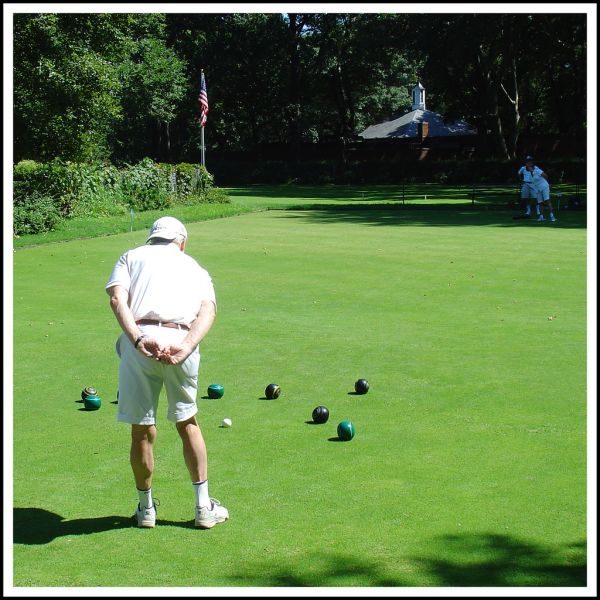 Bowler playing on a well-kept bowling green
