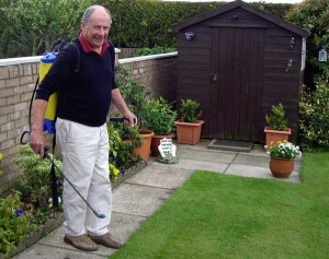 Duncan Gray practising his lawn care teachings - Spraying a lawn in his home town