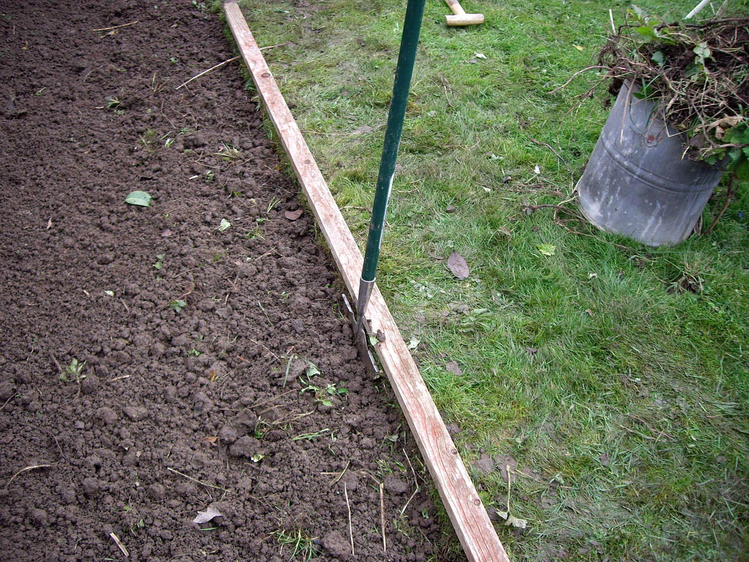 A half moon edger being used for lawn edging in winter